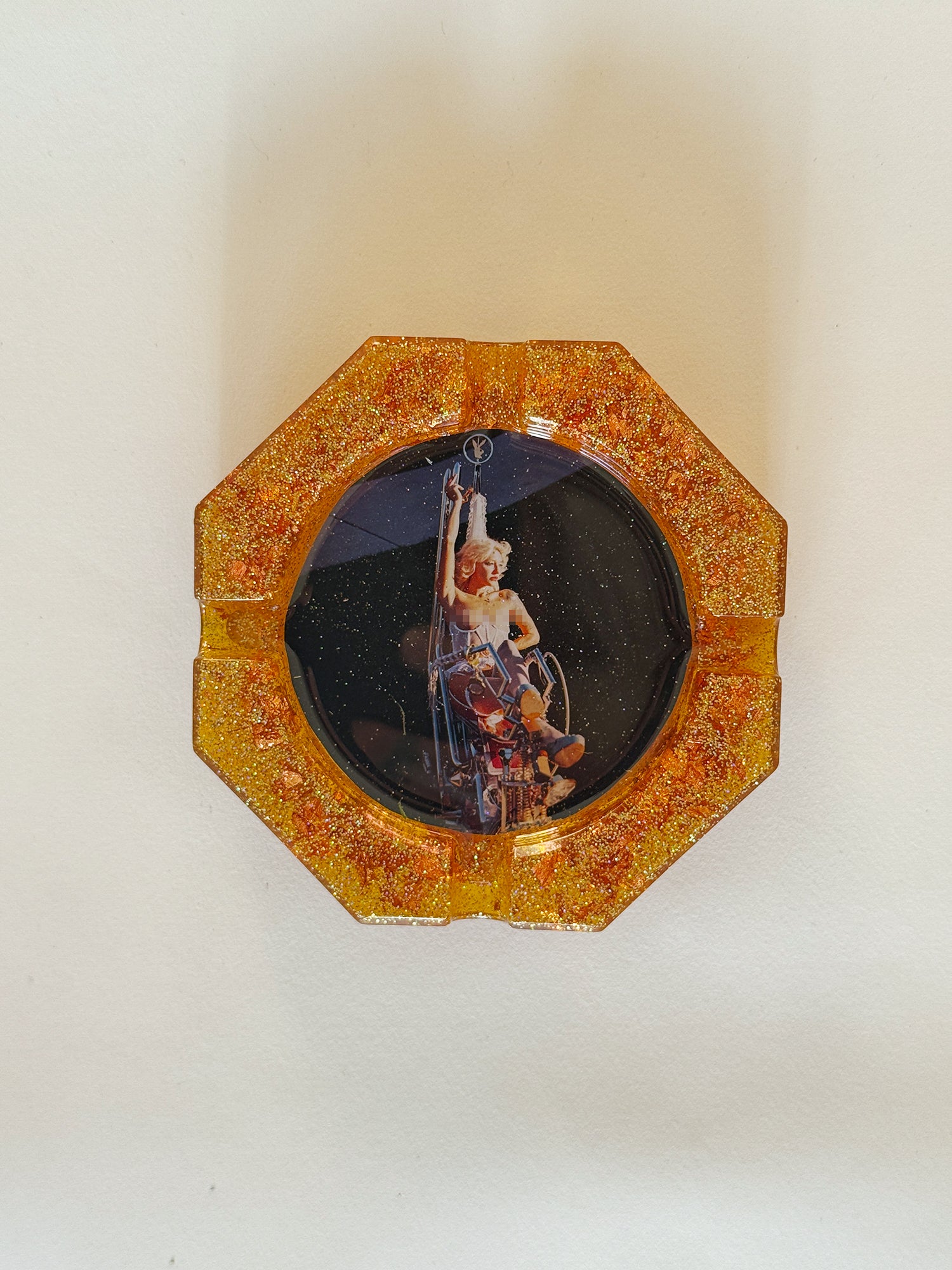 Decorative item with a central image of a person in a wheelchair on a white background