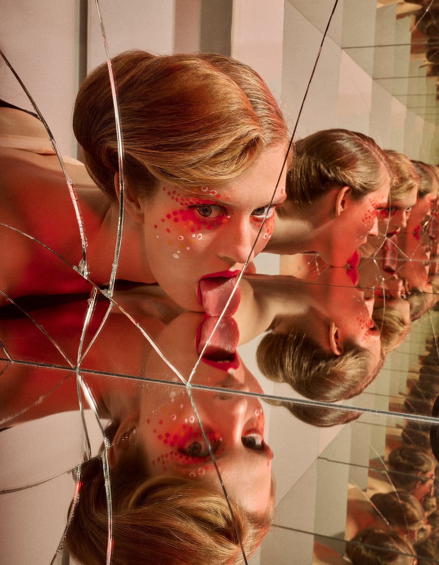 A creative artwork depicting a person with a bun hairdo looking into a cracked mirror with multiple reflections, with red avant garde makeup on the face.