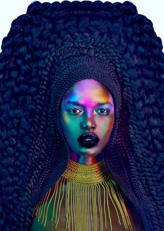 Black Sudanese woman with colorful tribal makeup on her face and giant high braids framing her face and filling the image.