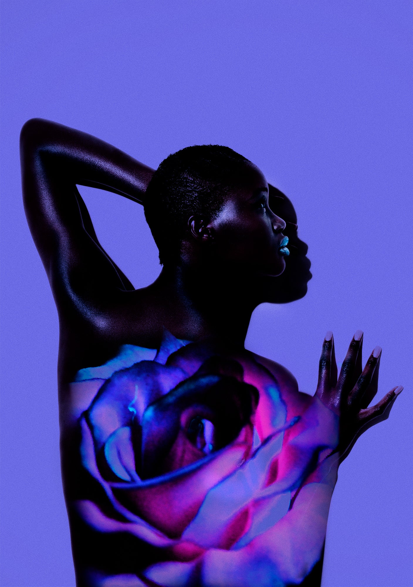 Portrait profile of a dark black woman against a purple wall with a collage of a purple and pink roses on her back. Her hand is on the wall and her face is creating a graphic shadow.