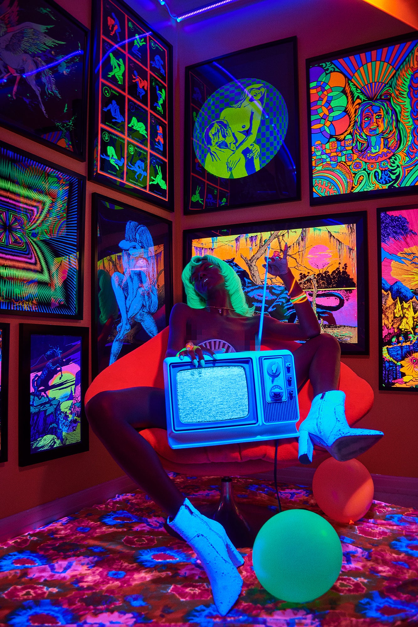 Black model girl with analog tv surrounded by glow-in-the-dark sex posters from the 60s trippy psychedelic