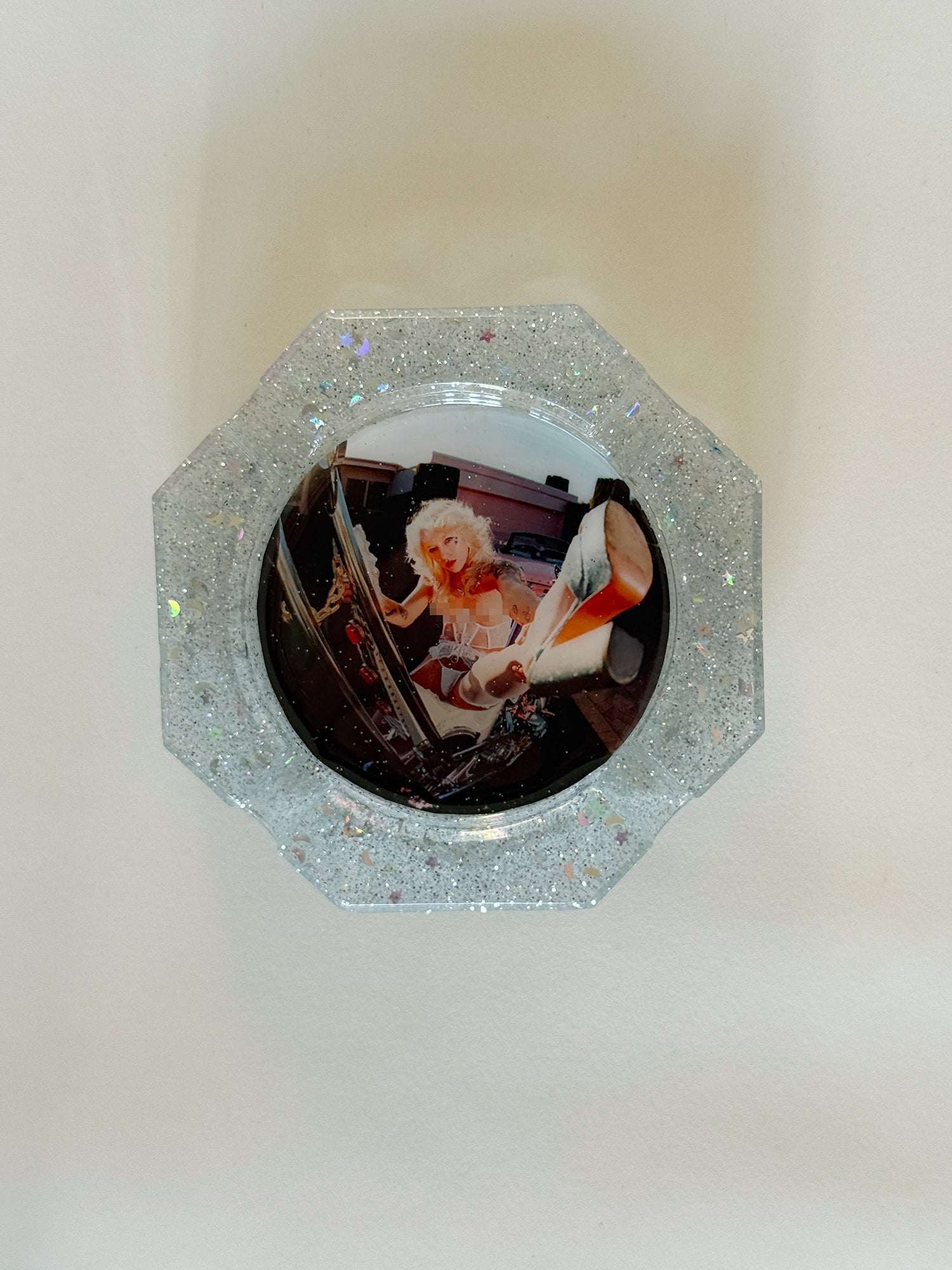 Decorative mirror with a glittery frame on a white background