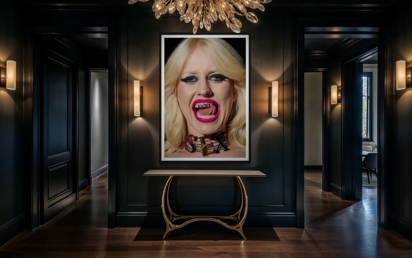 A black room with a large framed artwork of a punk girl, Amy Taylor with neon pink lipstick on and 'CUNT' written on her teeth as she sticks her tongue out.