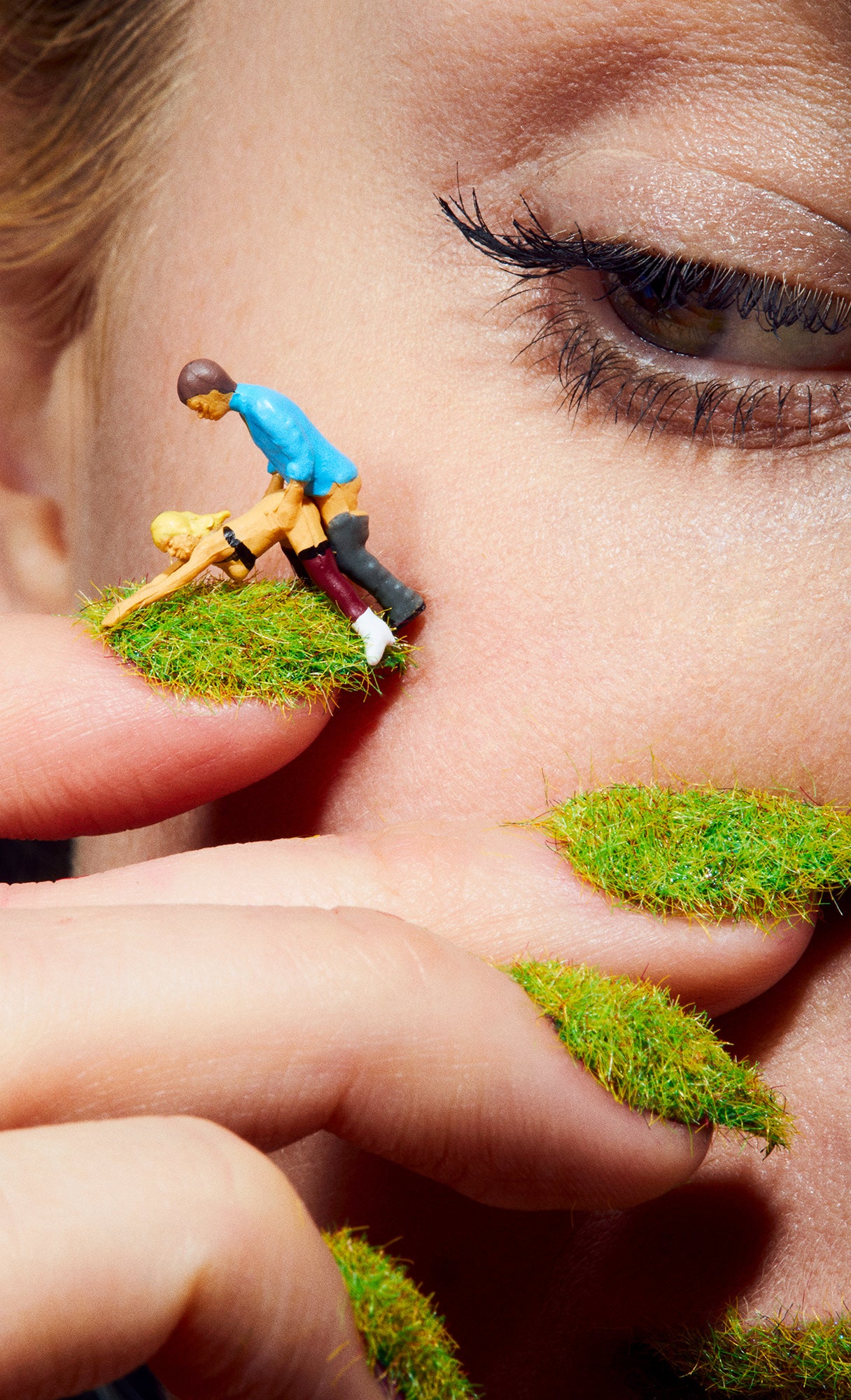 Closeup Macro of woman's eye looking at two people having sex on lawn dollhouse miniature dolls sex dolls grassy nails manicure humorous wall art