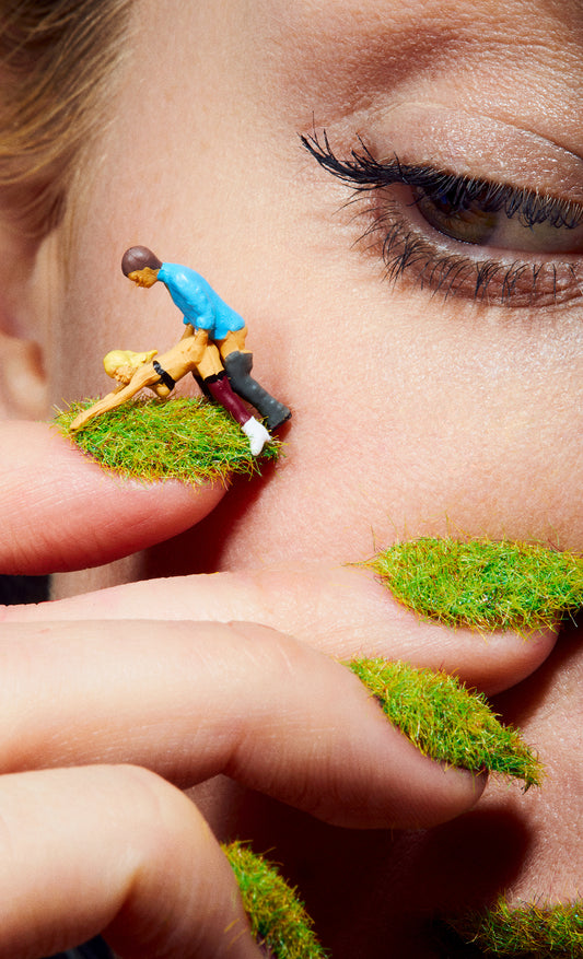 Closeup Macro of woman's eye looking at two people having sex on lawn dollhouse miniature dolls sex dolls grassy nails manicure humorous wall art