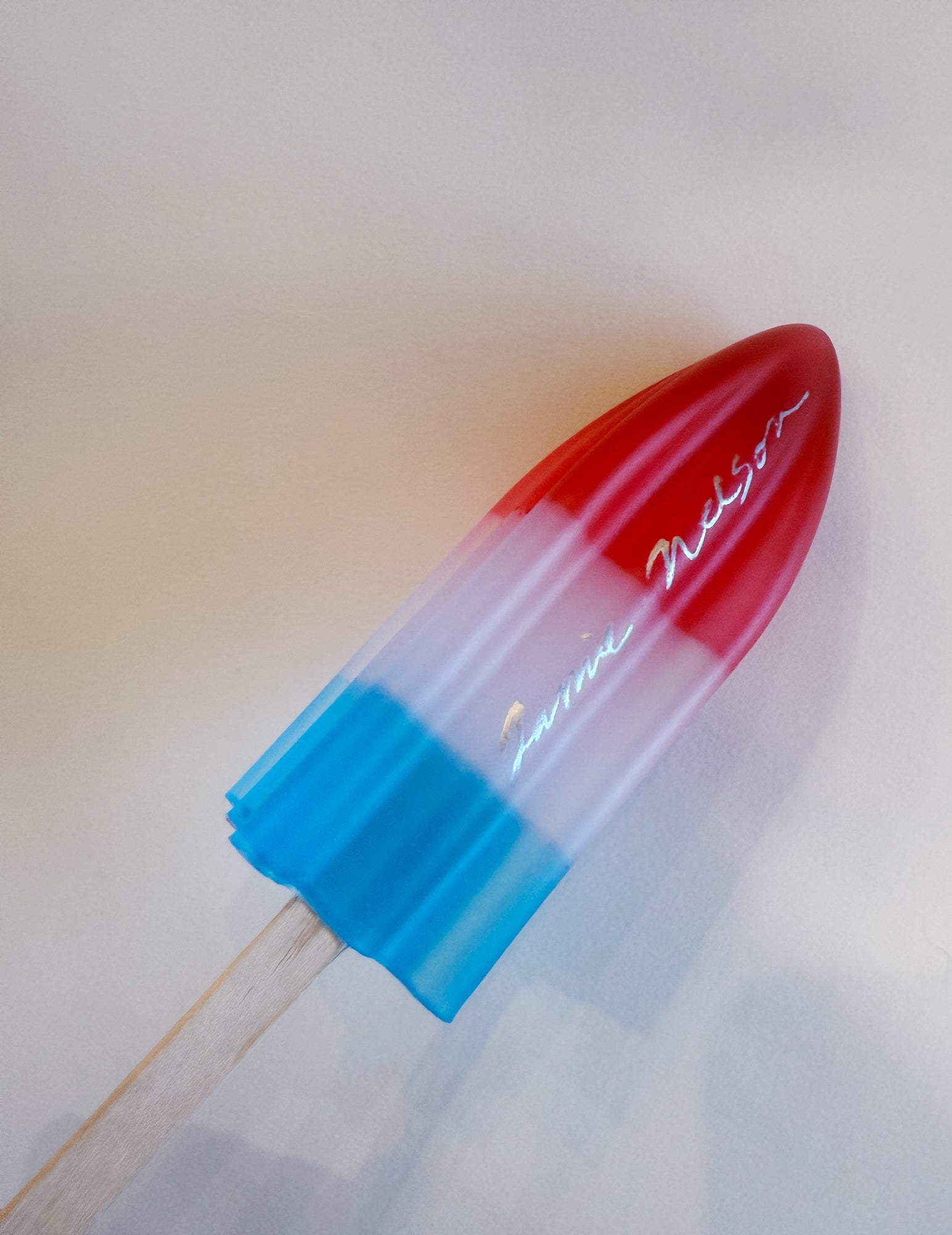 Red and blue rocket pop with 'Jamie Nelson' branding on a white background