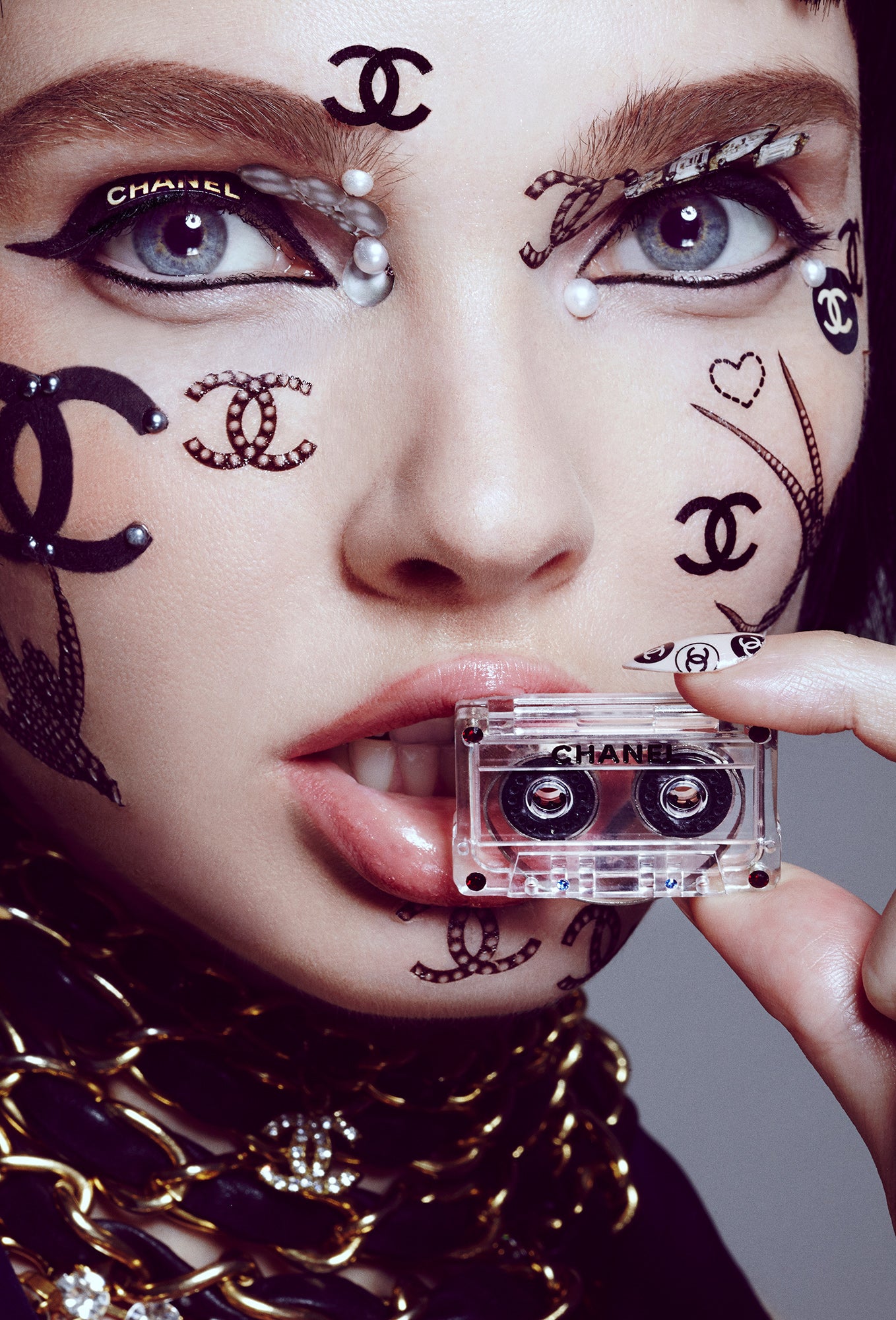 brand whore designer luxury addict woman covered in chanel face stickers and tattoos