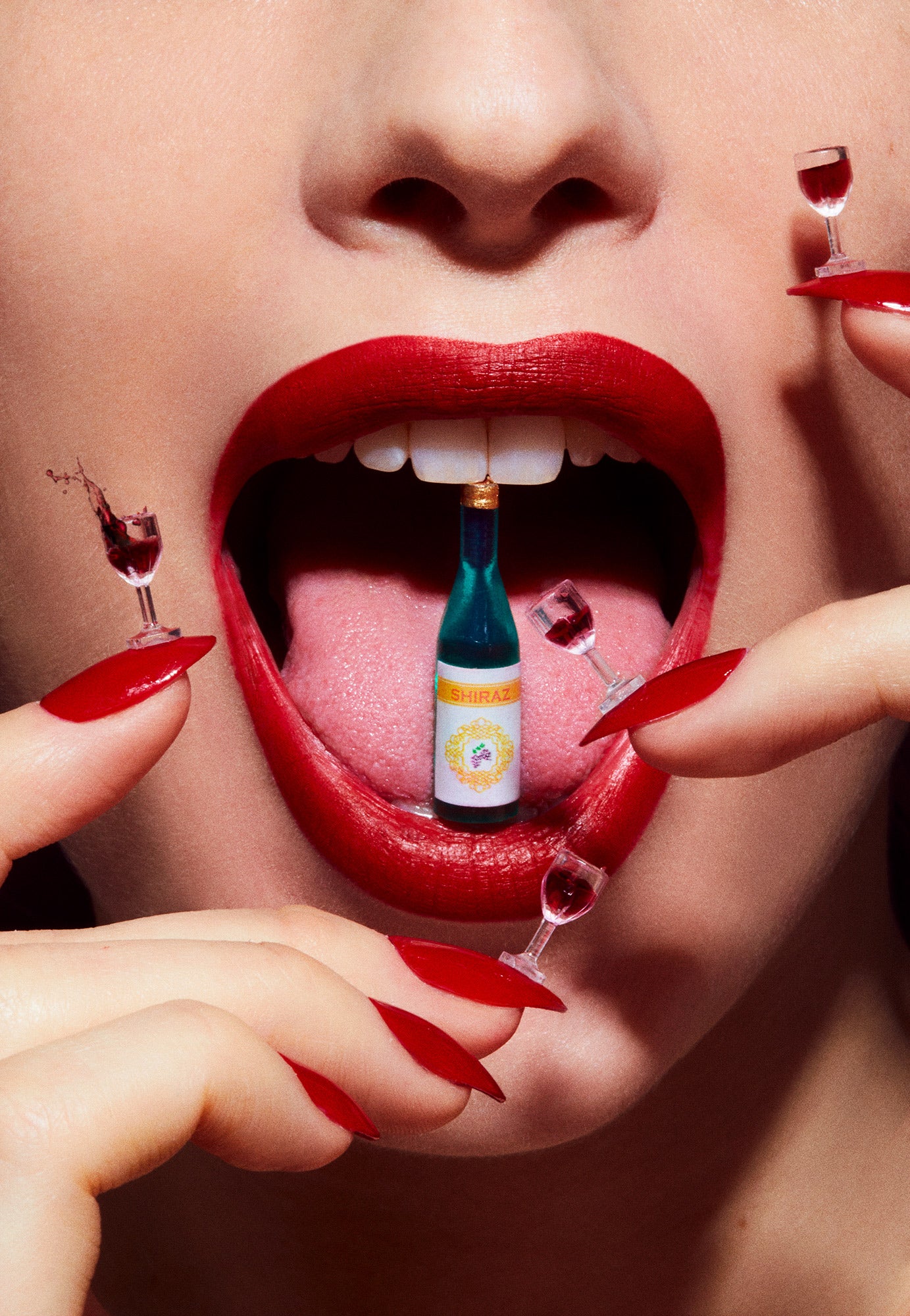 Close up macro photography of woman's lips smiling laughing and celebrating with tiny wine glasses on her fingernails