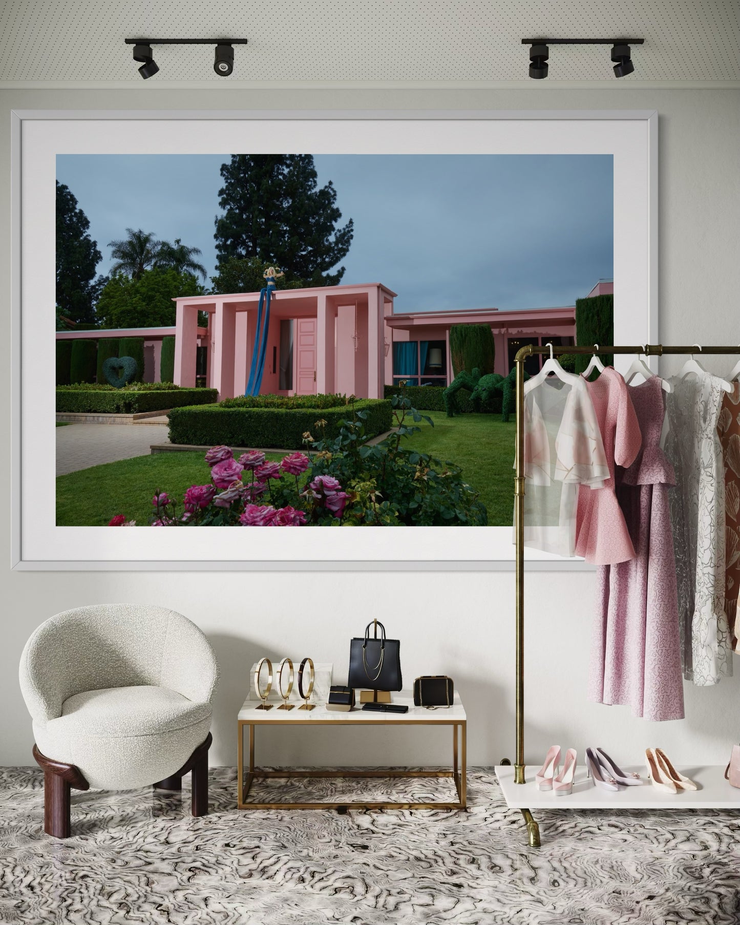 Framed photograph of a pink building with greenery in a stylish interior setting.