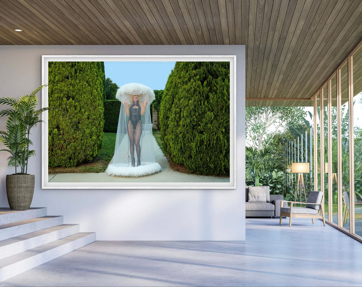 Large framed photograph of punk front woman Amy Taylor of Amyl and the Sniffers as she flips the bird wearing a large marabou feathered veiled hat.
