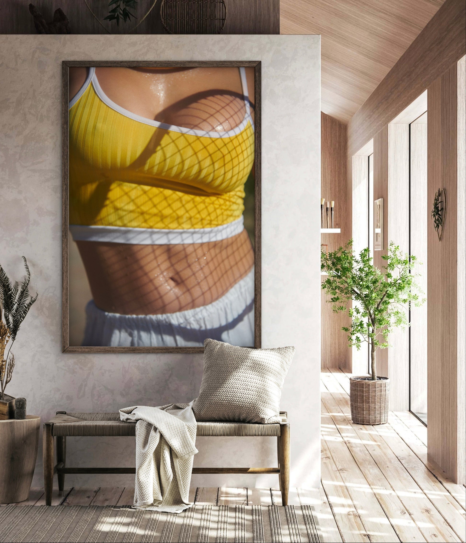Artistic framed art hanging in a gym spa location of a torso of a female tennis player with tennis racket shadows on her breasts and stomach.