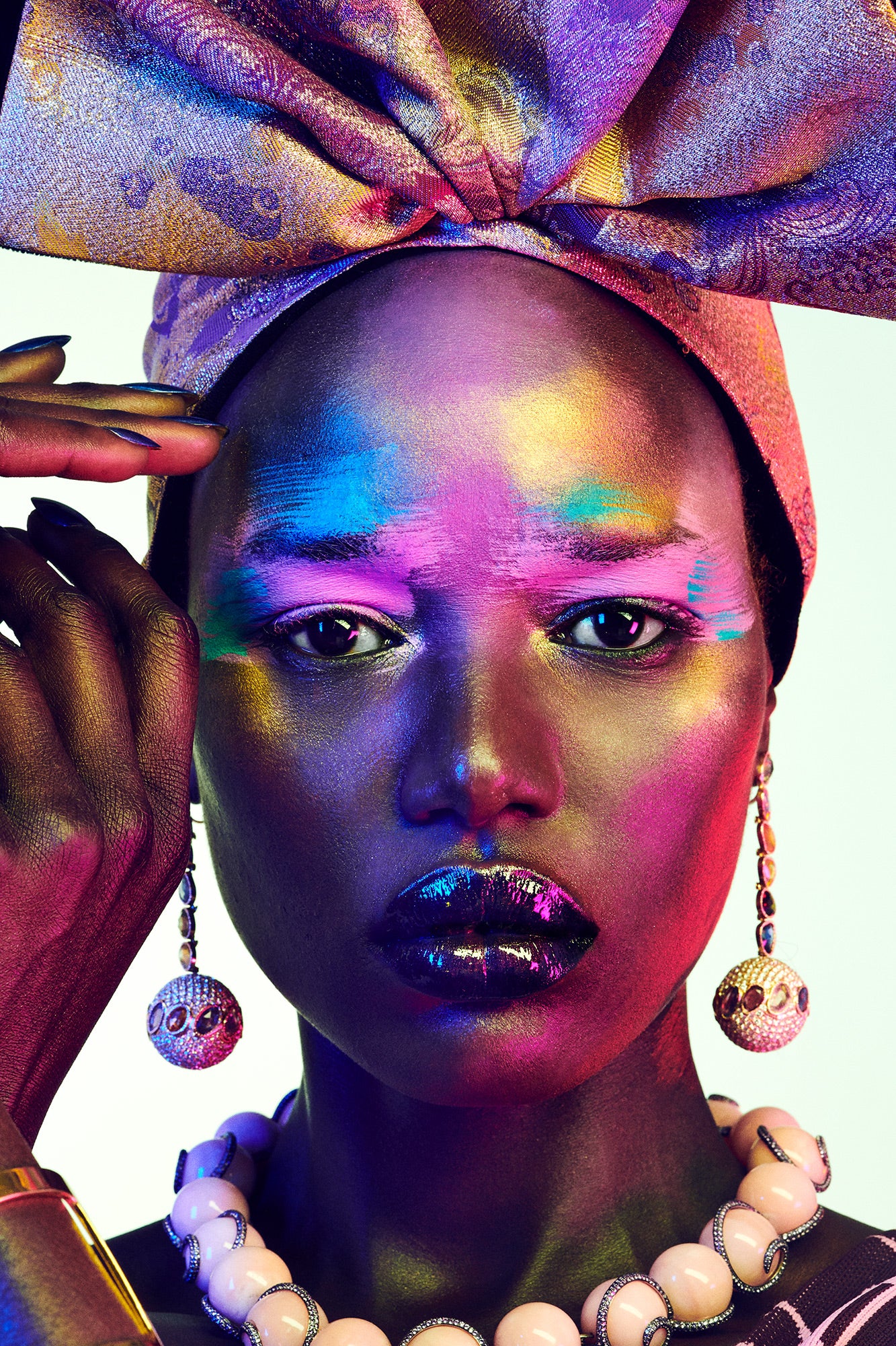 Black woman with colorful tribal makeup wearing ethnic traditional turban. African queen fine art wall decor photographed by Jamie Nelson, los angeles famous fine art photographer.
