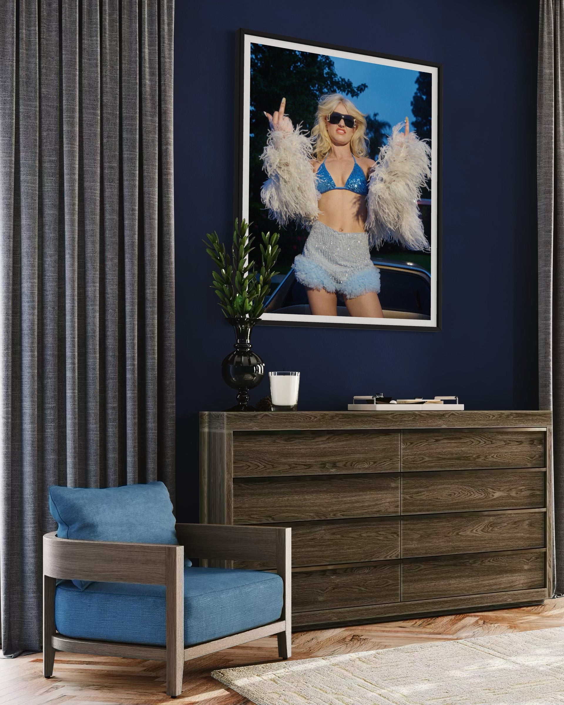 Room interior with a blue armchair, wooden dresser, and framed picture on a dark blue wall.