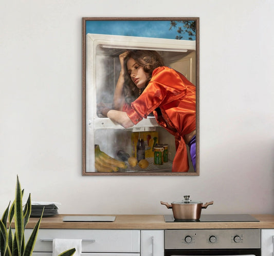 Framed artwork of a woman reaching into an open refrigerator in a kitchen setting.