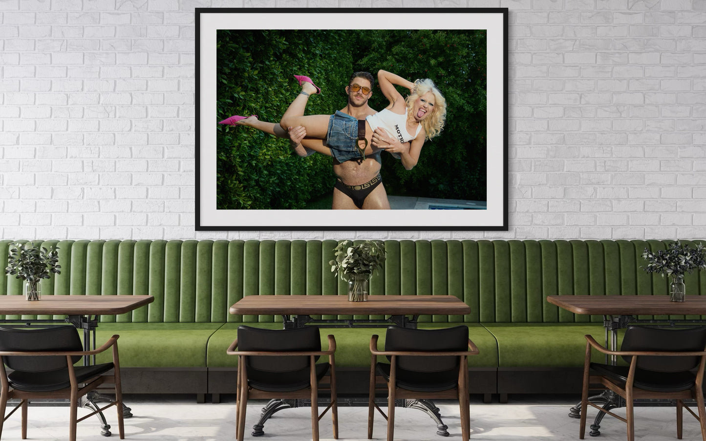 Framed artwork of Amy Taylor, Amyl and the Sniffers, sticking her tongue out as a buff man lifts her up.
