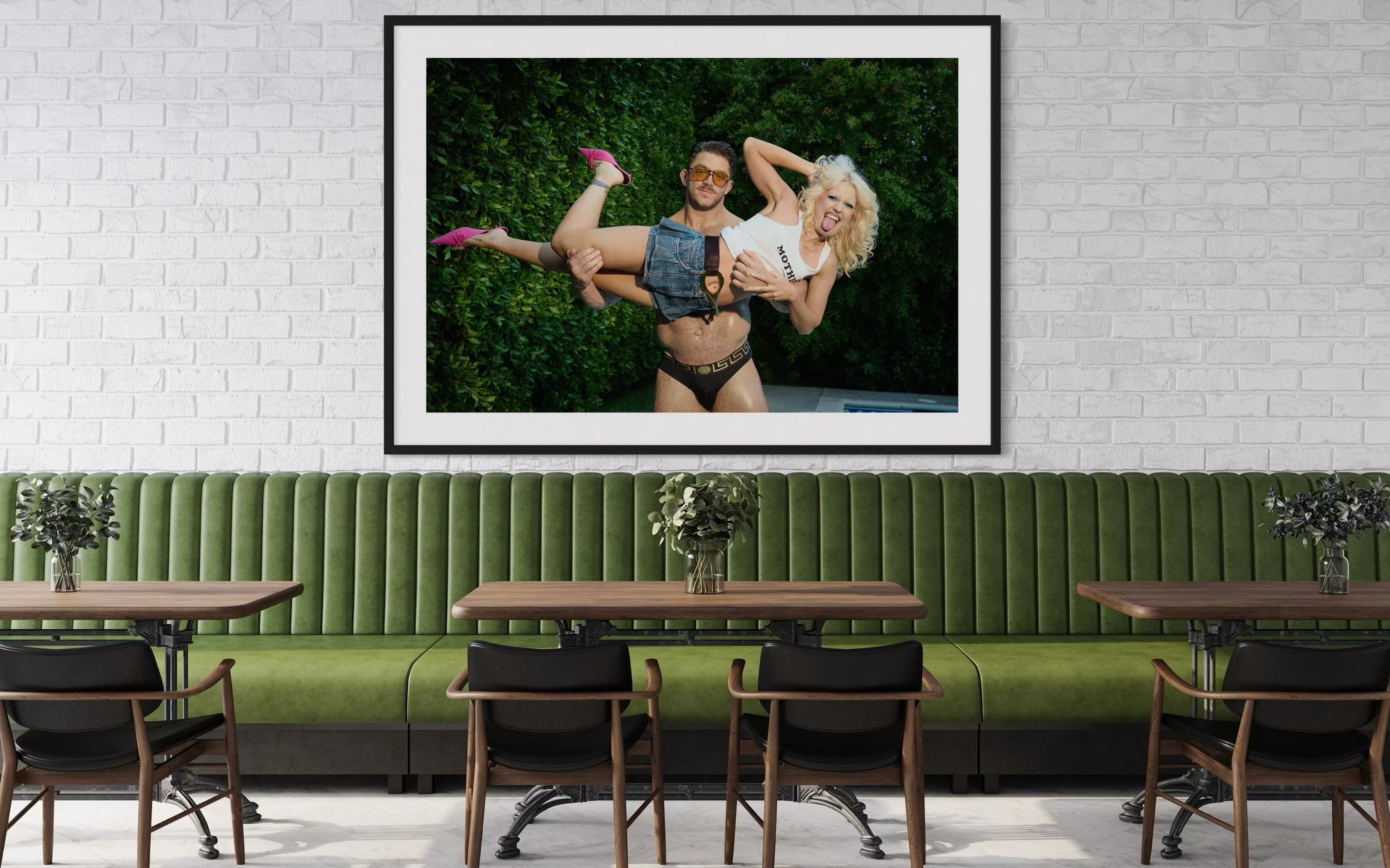 Framed artwork of Amy Taylor, Amyl and the Sniffers, sticking her tongue out as a buff man lifts her up.