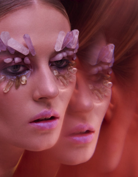 avant-garde makeup beauty editorial of woman with lavender crystal therapy stones on eyes 