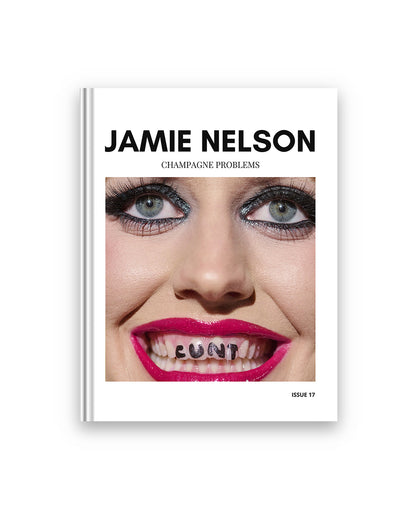 Book cover with a face and text 'Jamie Nelson Champagne Problems' on a white background. A square photo is in the middle featuring a punk girl with black eyeliner and magenta lipstick and the words 'Cunt' written on her teeth.