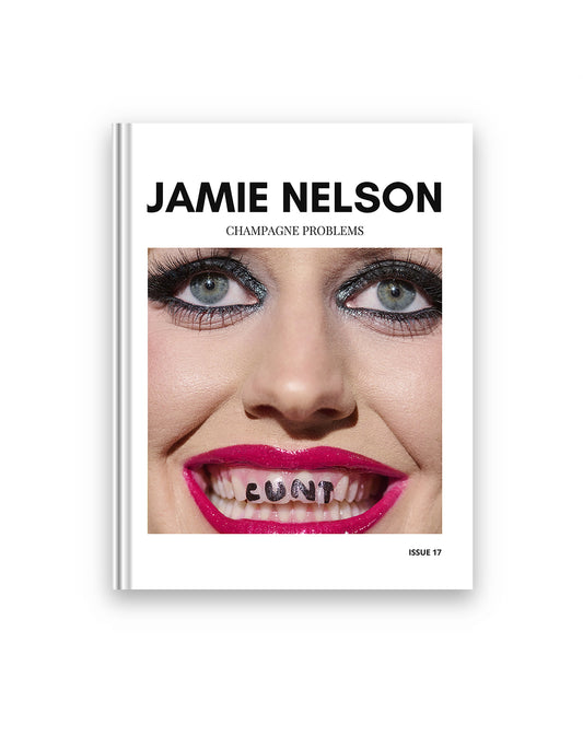Book cover with a face and text 'Jamie Nelson Champagne Problems' on a white background. A square photo is in the middle featuring a punk girl with black eyeliner and magenta lipstick and the words 'Cunt' written on her teeth.