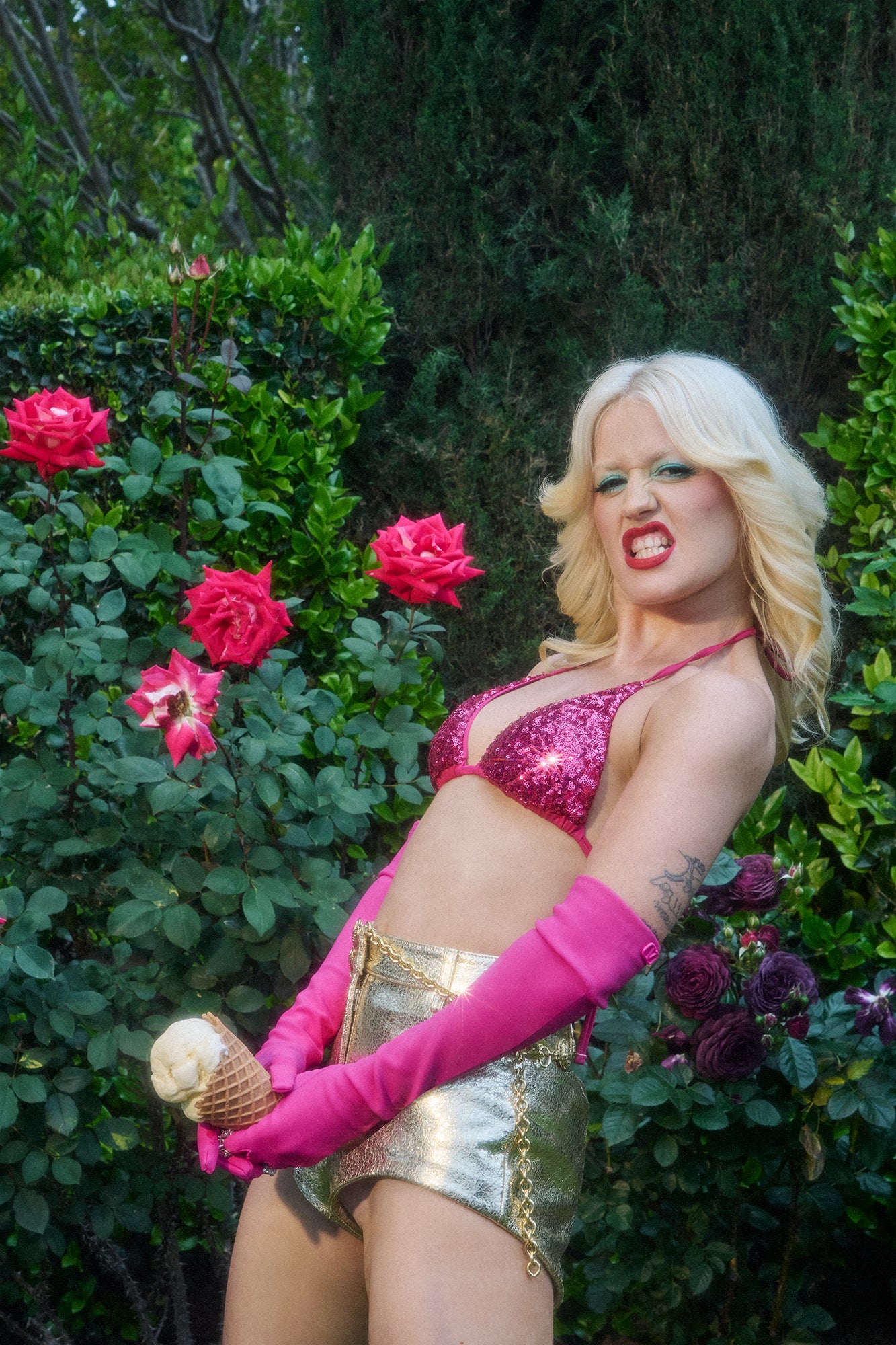 Amy Taylor (Amyl and the Sniffers) rebelliously grips an ice cream cone at her crotch, treating it as her phallus.