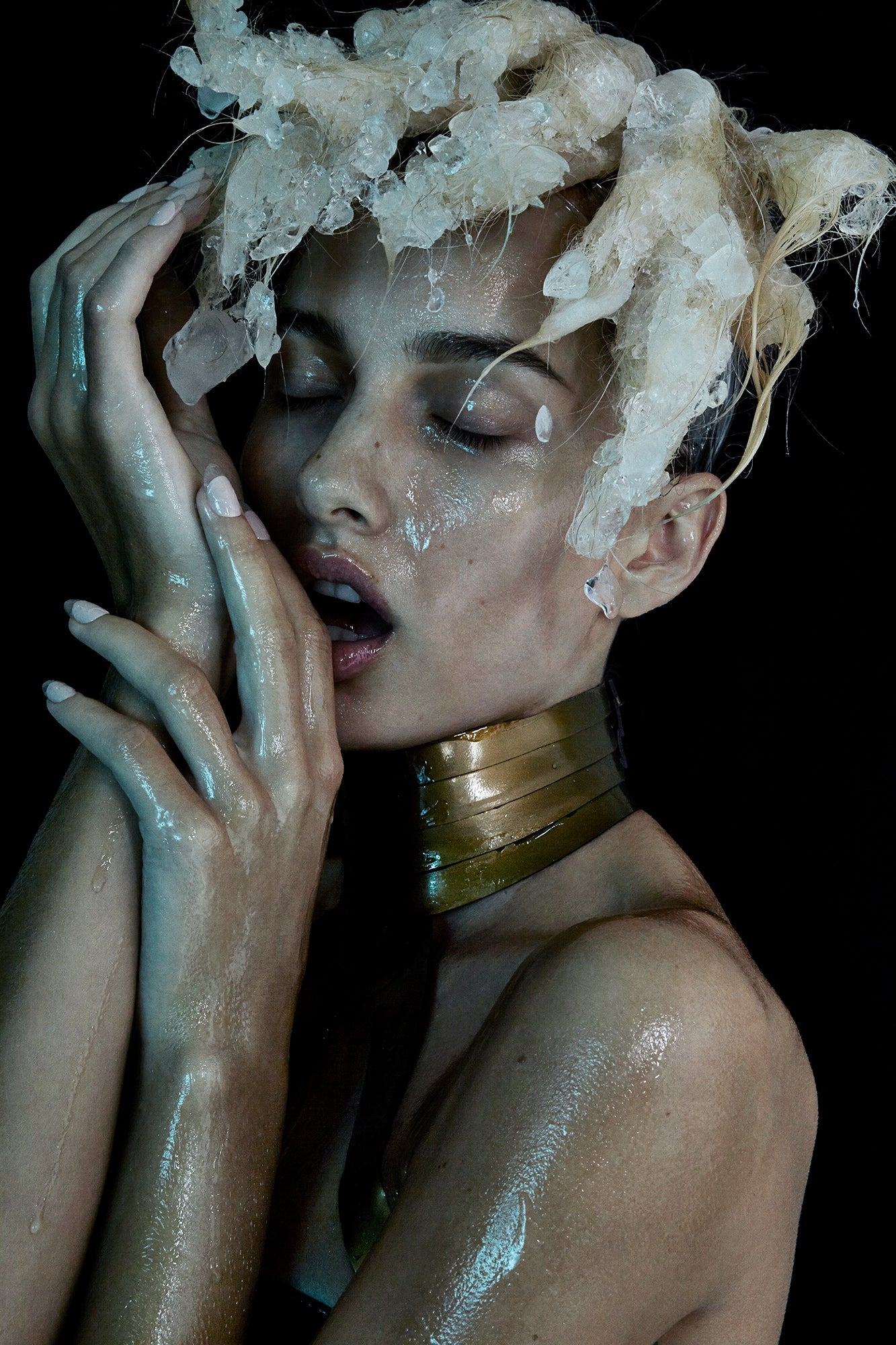 High Fashion editorial of female model girl with icicles and chunks of ice in her hair frozen hair 