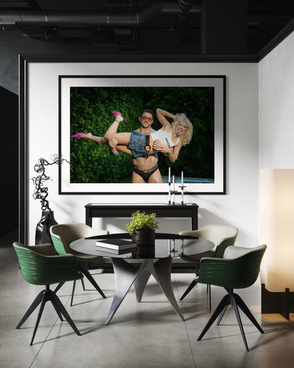 Large framed artwork of Amy Taylor of Amyl and the Sniffers being picked up by a buff man wearing Versace speedos.