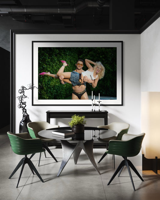 Large framed artwork of Amy Taylor of Amyl and the Sniffers being picked up by a buff man wearing Versace speedos.