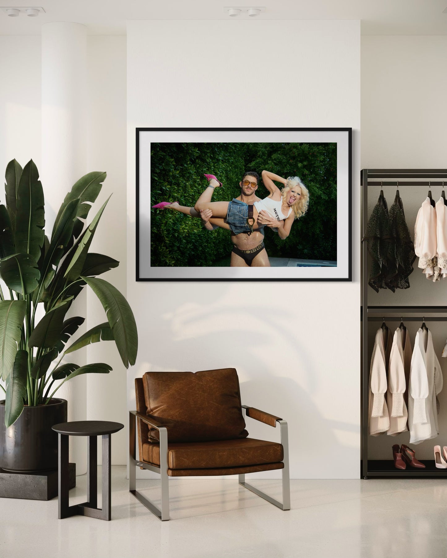 Framed photograph of a buff guy lifting up a blonde woman, Amy Taylor of Amyl and the Sniffers as she sticks her tongue out and smiles.