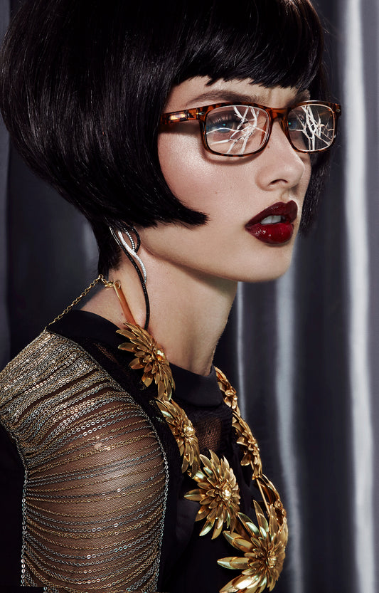 Elitist girl wearing expensive jewelry with black bob haircut wearing shattered eyeglasses