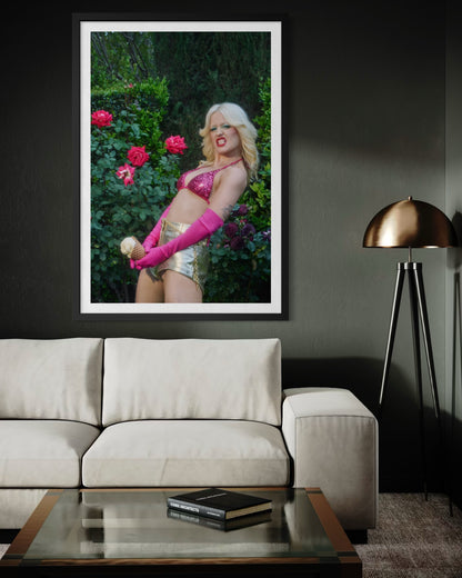 Fine art print of a 70's style glam rock woman dressed in a sequin pink bikini with a flipped-out hair style and gold disco shorts. She is in a rose garden holding an ice cream cone near her crotch, displaying her "big dick energy".