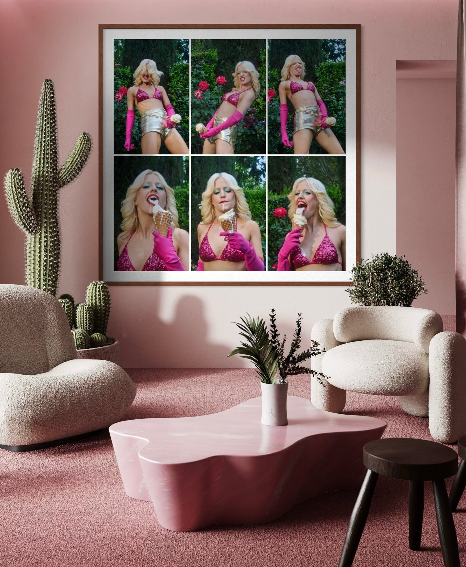 A pink living room with cacti deco and a large framed image that contains six smaller portraits of Amy Taylor making rebellious poses with a phallic ice cream cone.