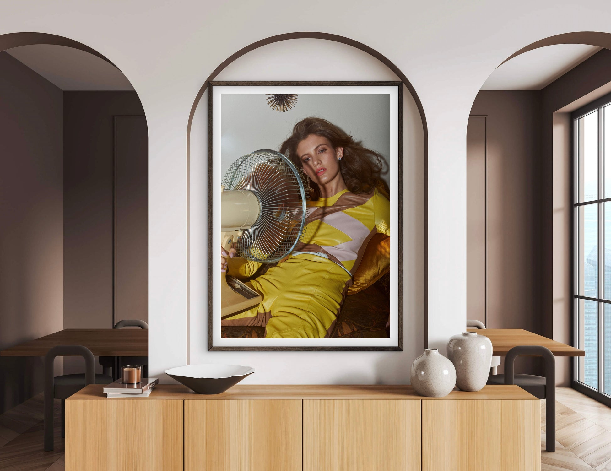 Framed artwork of a woman with a fan on a wall in a modern room.