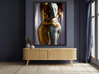 Framed artwork of nude women covered in metallic body paint while embracing in a messy hug.