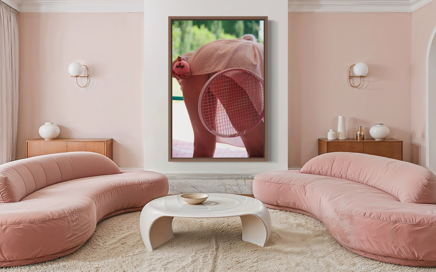 A modern pink living room with a large framed photograph of a retro style woman bending over to serve tennis as her butt  is exposed.