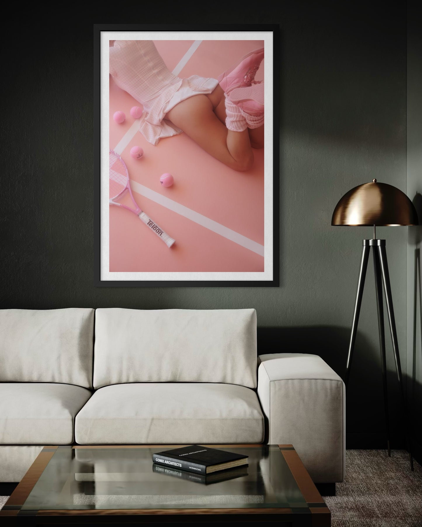 A modern masculine living room with a framed artwork of a woman's buttocks showing underneath her short tennis skirt. She is wearing pink reebok 80s shoes and pink tennis balls and tennis racquet are strewn on the ground.