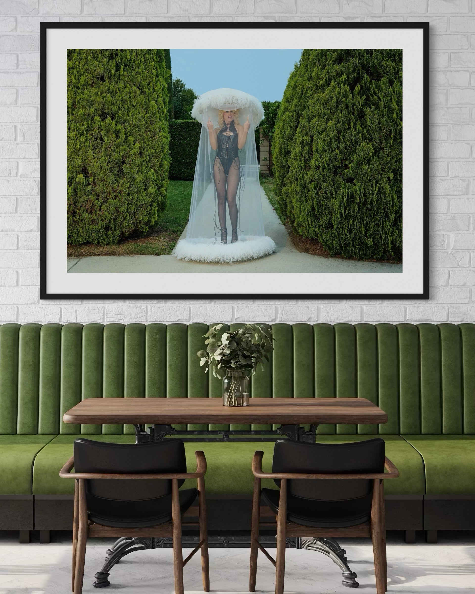 Framed artwork of a punk woman Amy Taylor of Amyl and the Sniffers as she flips the camera off while wearing a white veiled hat in a garden setting.
