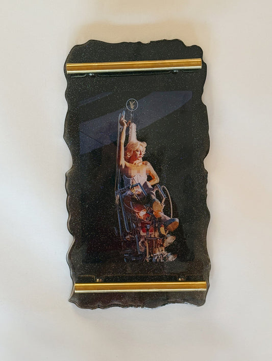 70s chopper motorcycle woman topless on glitter resin tray in the style of Easy Riders magazine.