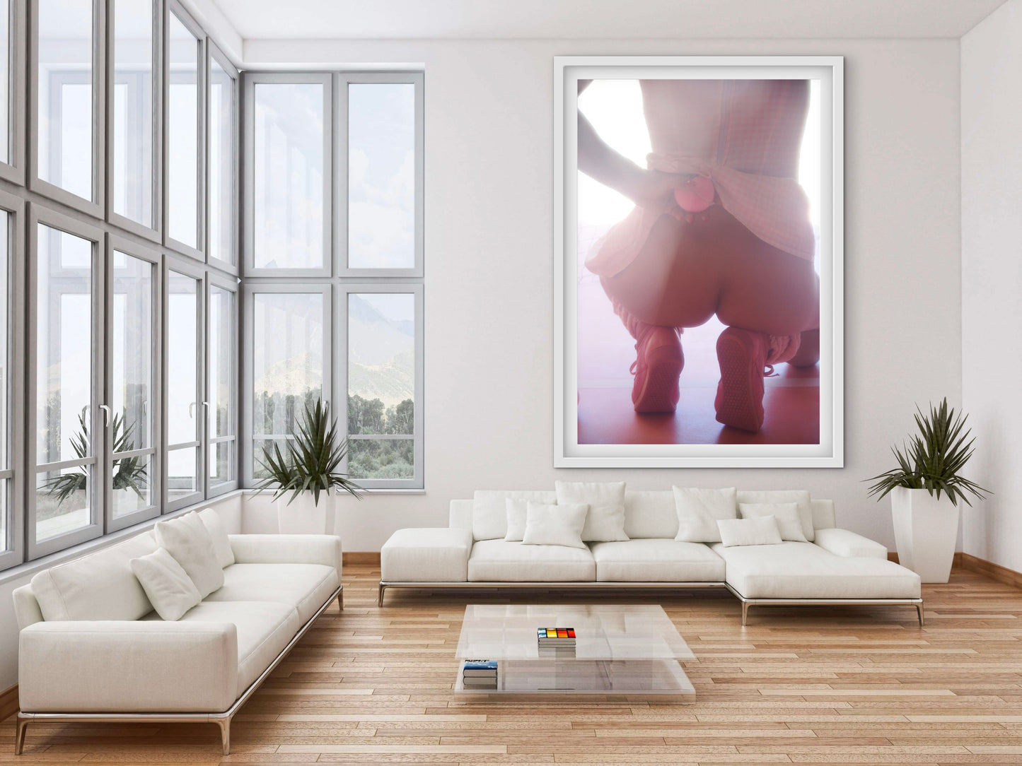 Modern living room with white furniture and a large framed picture on the wall of an 80s retro style sexy nude tennis player wearing pink.