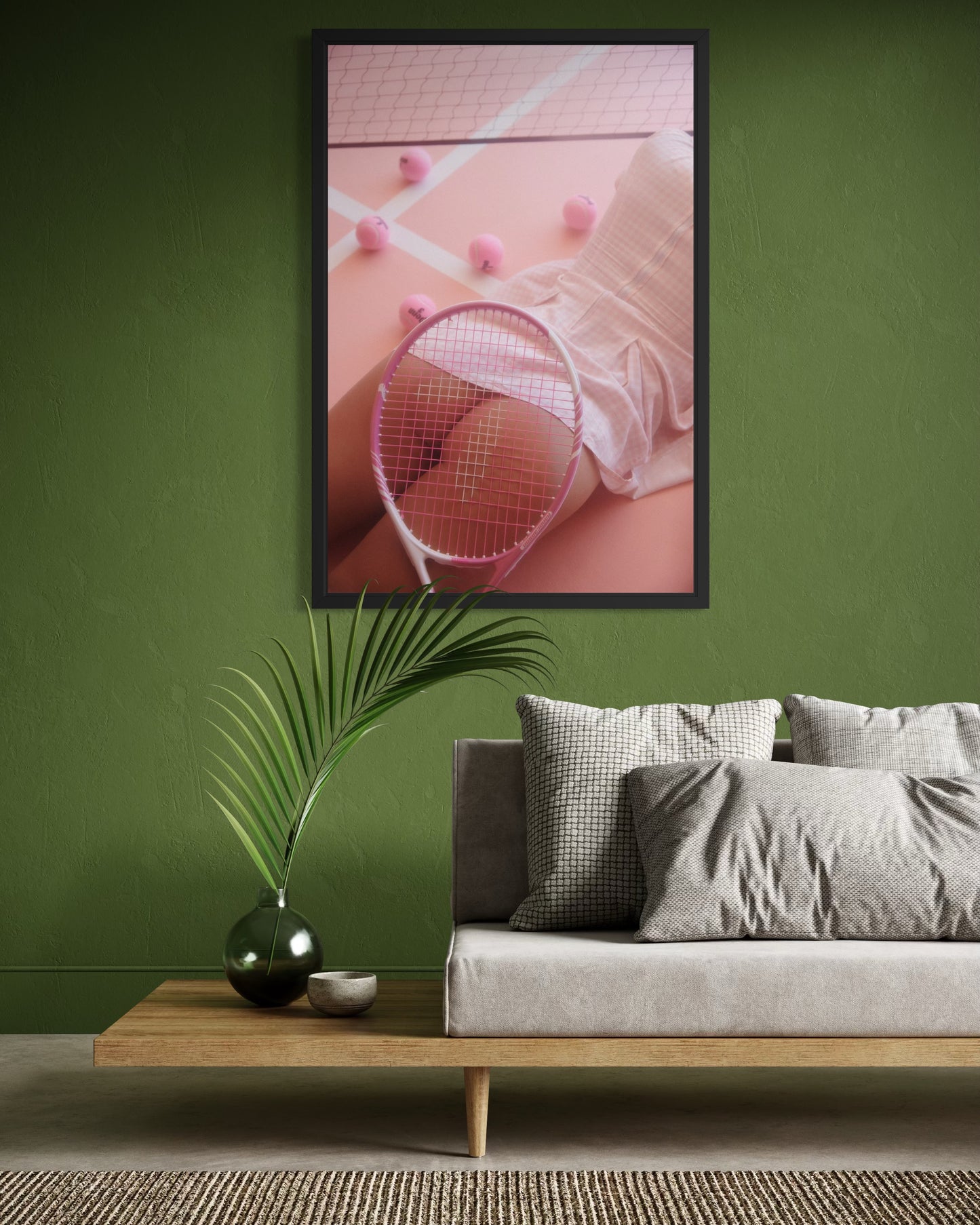 Framed fine art photo of a woman laying down on a pink tennis court wearing a gingham pink tennis skirt with her nude buttocks exposed and a tennis racket obscuring it.