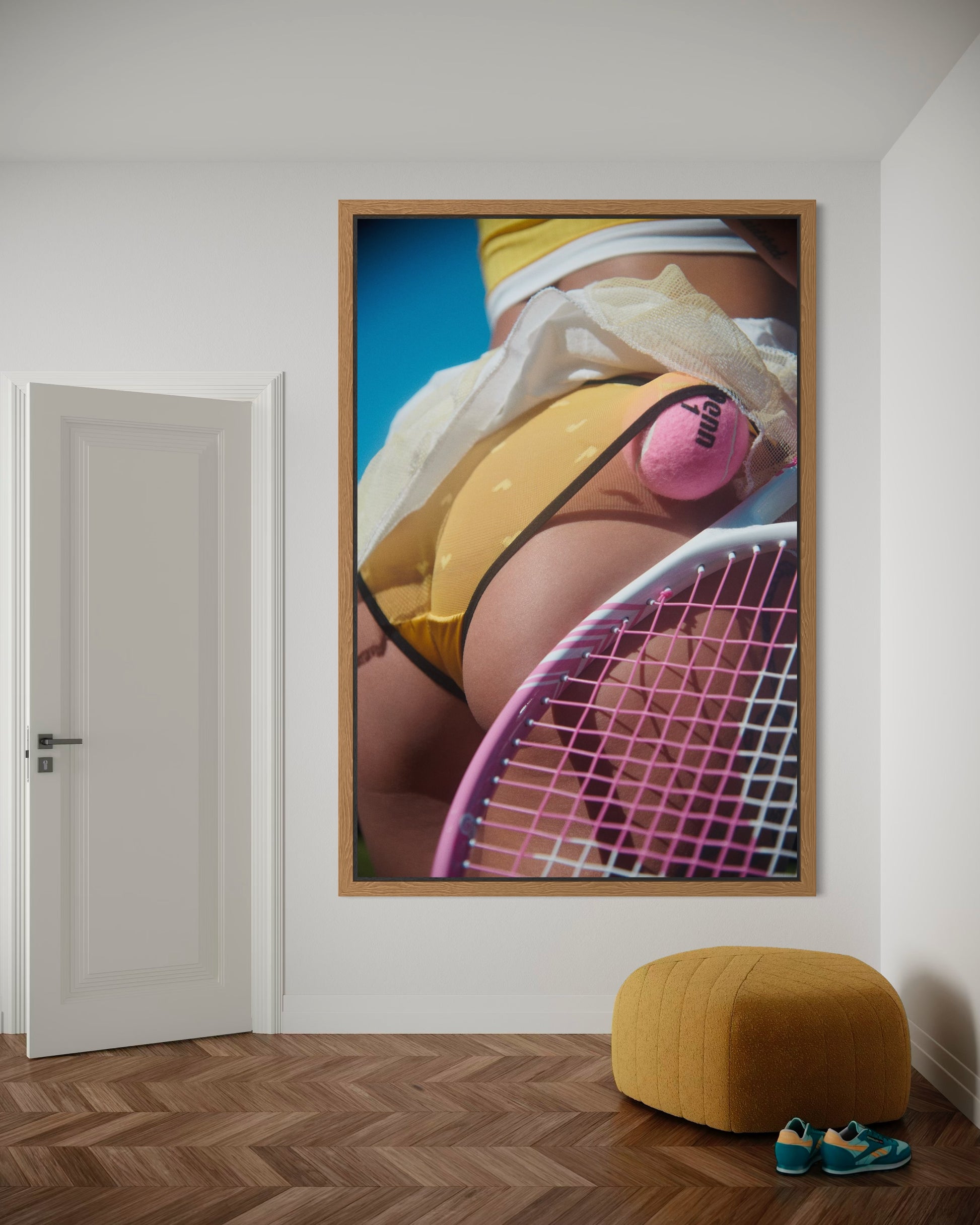 Framed artwork of a sexy woman's butt holding a tennis racket with a pink ball.