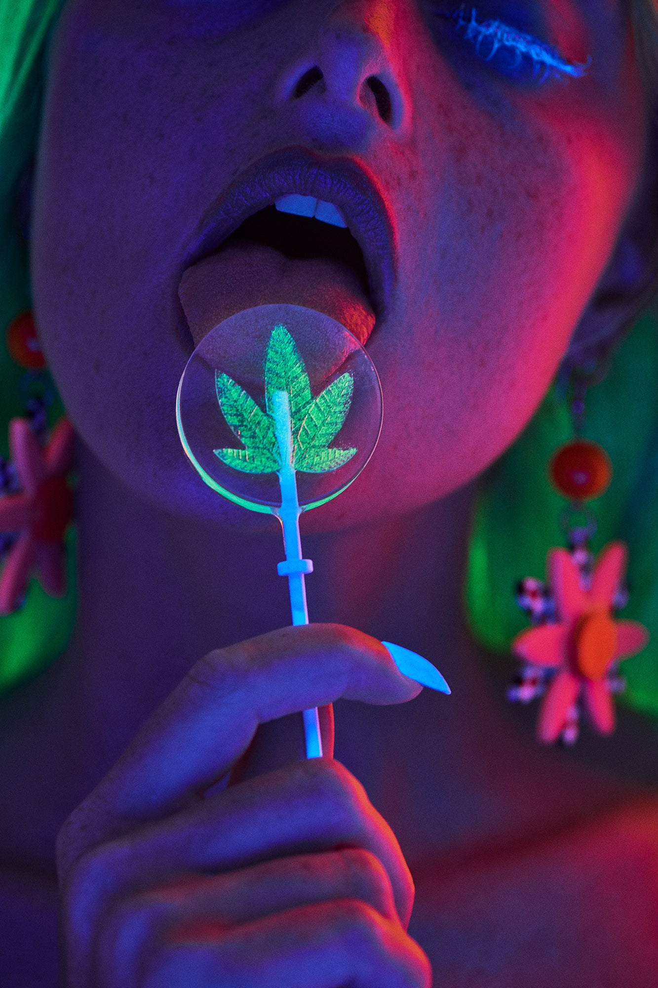 Girl sucking licking cannabis gummies candy lolipop sucker neon lights red light blue eyelashes psychedelic colors