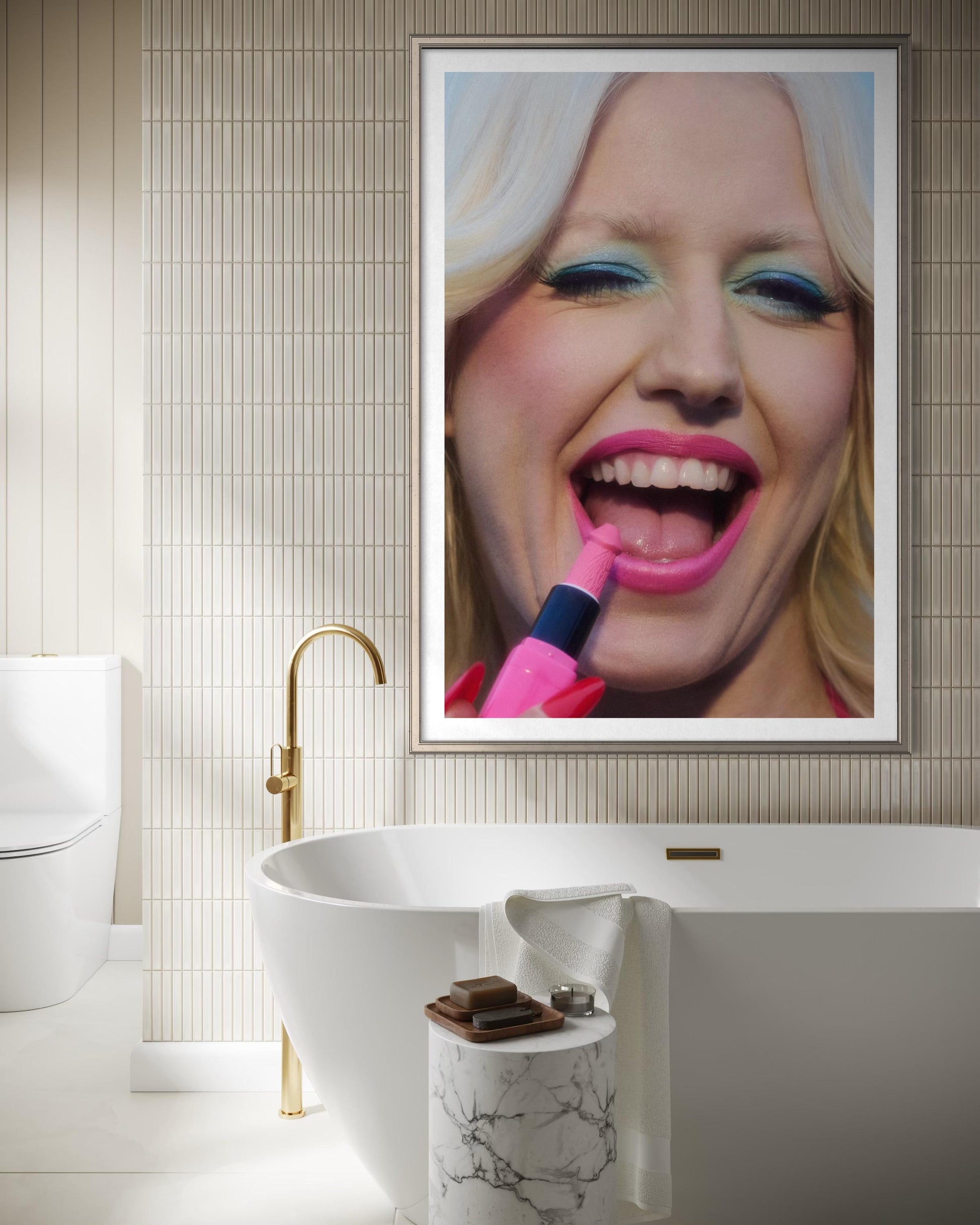 Bathroom with a framed artwork of a woman applying lipstick. She wears vintage style rocker makeup and has a 70s blonde flip-out hair style.