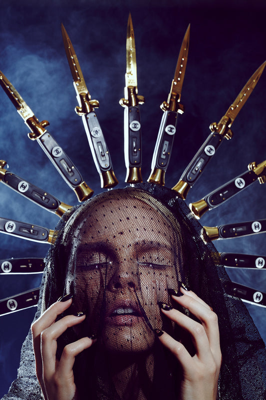 A stylized artistic portrayal of a person with a switchblade crown, reminiscent of a halo, with the individuals' face obscured by the blades.