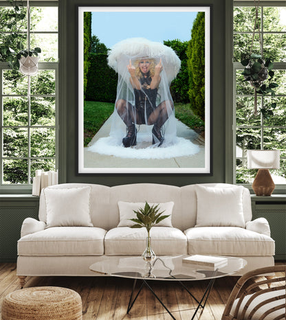 Living room with a large framed picture of a woman in a veil, sofa, and coffee table.